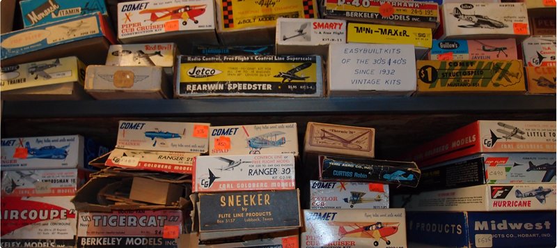lots and lots of kits on metal shelving in the collections space of the National Model Aviation Musuem.